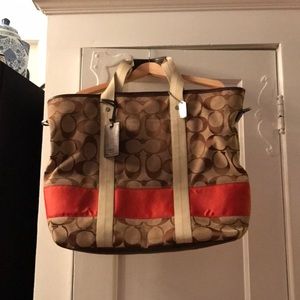 Oversized coach tote with luggage tag.